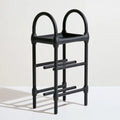 Black metal shoe rack from LedgeandLilac, three-quarter view showing multiple tiers for organizing shoes.