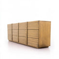 Contemporary grey double dresser by LedgeandLilac with sleek design, shown from a three-quarter view in a modern setting.