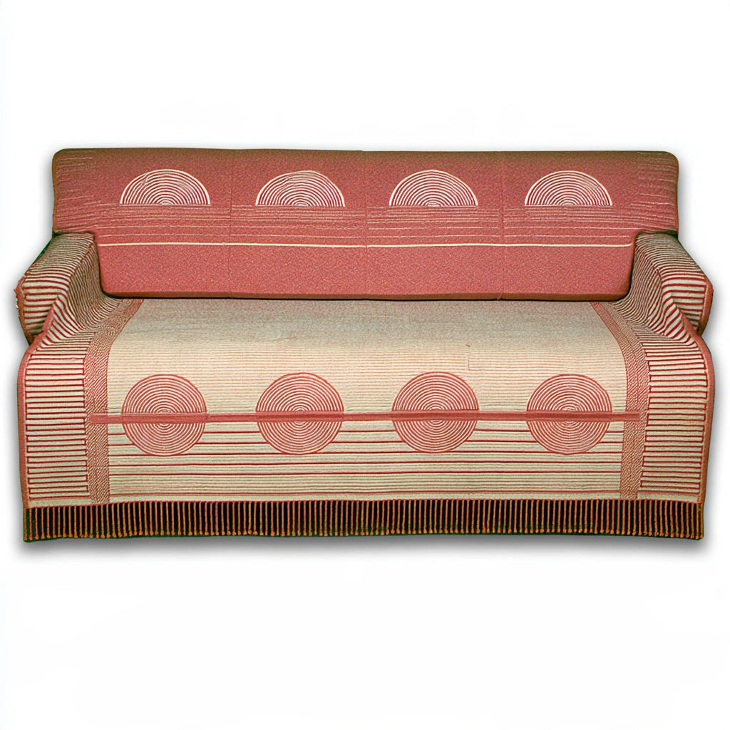 Gray upholstered three-seater sofa from LedgeandLilac draped with a woven jacquard throw blanket.